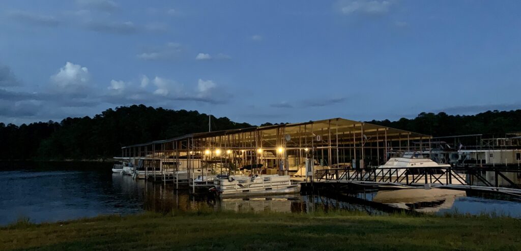 Boat storage Lincolnton, GA at Plum Branch Yacht Club marina with covered slips on Lake Thurmond at dusk